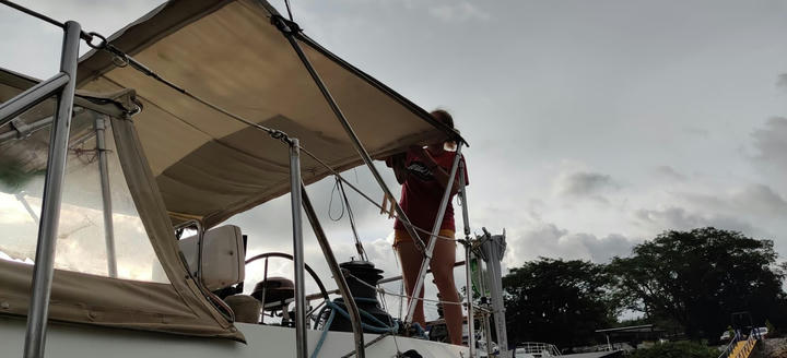 Marie cleaning the bimini